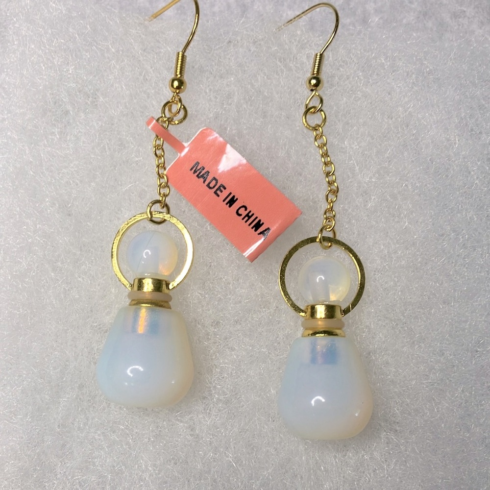 NWT Large dangle earrings with a white bead and gold colored metal.